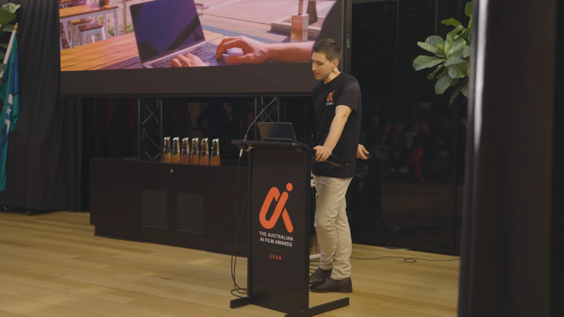 On stage at The Australian AI Film Awards in Brisbane, the trophies lined up beside the lectern